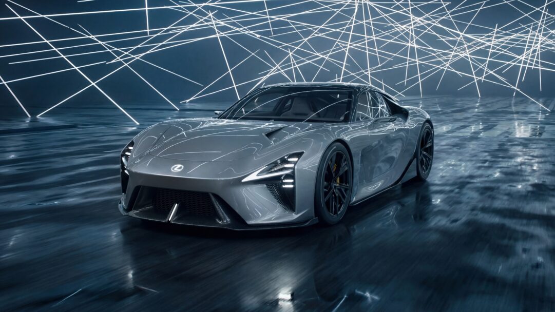 A cutting-edge 4K wallpaper features a grey Lexus concept car, highlighting its futuristic lines. The sleek vehicle is positioned on a dark, reflective floor, vividly lit by a dense network of glowing white lines that crisscross the background and reflect dynamically across the wet surface.