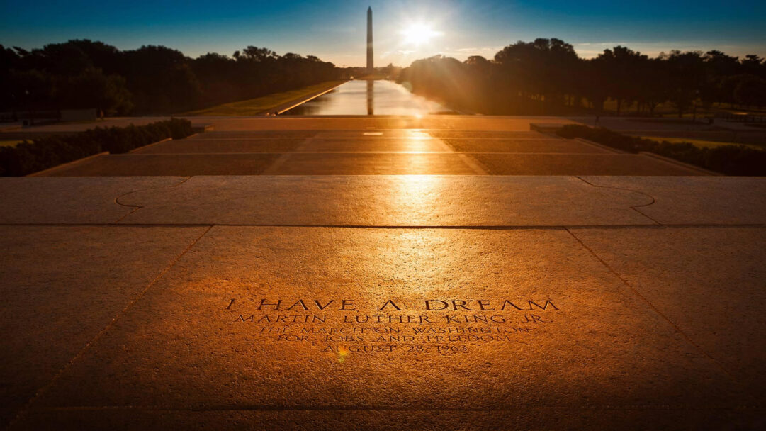 A powerful 4K wallpaper highlights the Washington DC Lincoln Memorial Steps, distinctly marked with the I Have a Dream inscription from Martin Luther King Jr.'s historic speech. The setting sun bathes the textured stone in a golden glow, beautifully illuminating the words and leading the eye towards the Reflecting Pool and the distant Washington Monument.